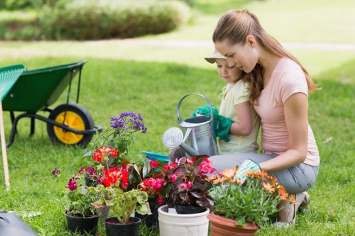 Insured gardeners reviewing compliance documents and safety gear